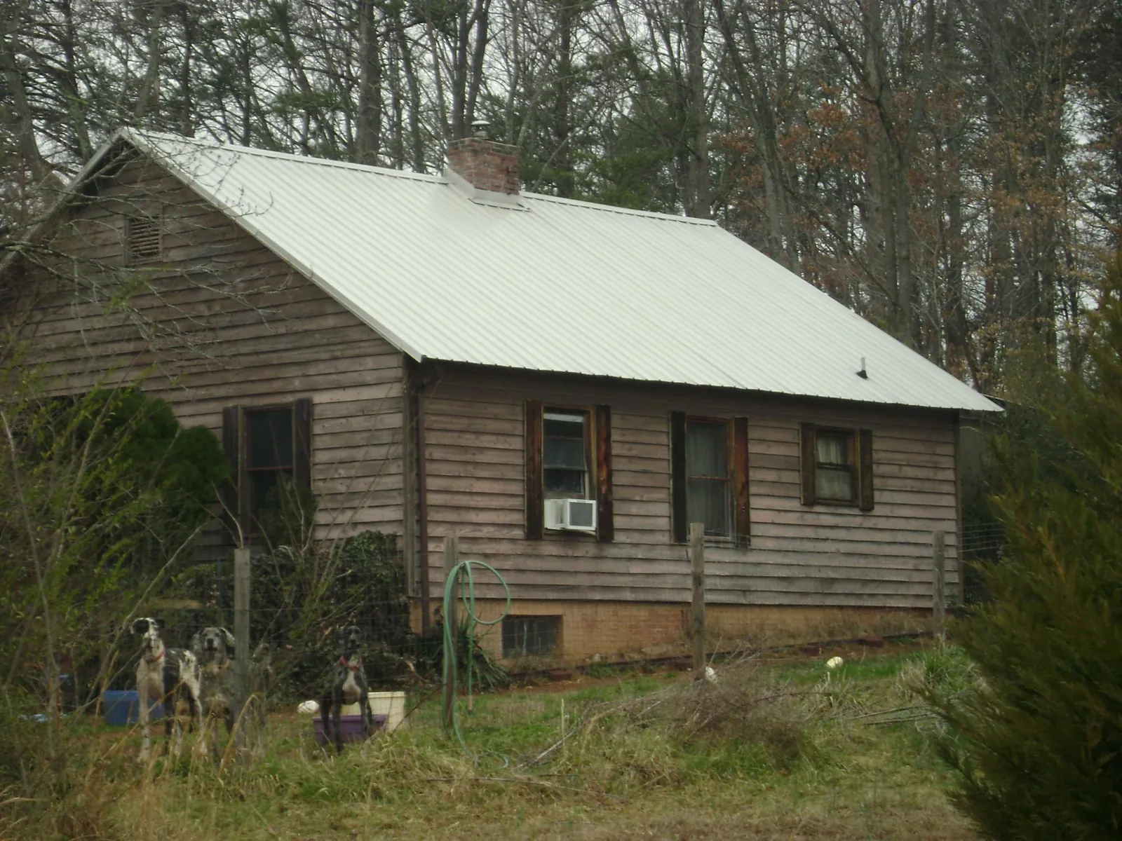 White metal roof on an old wood sided farmhouse, from a Asphalt Shingle Roof Repair job in Robbins